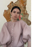 Celeni light pink knit cardigan with pearl buttons and 3/4 puff sleeves, round neck.